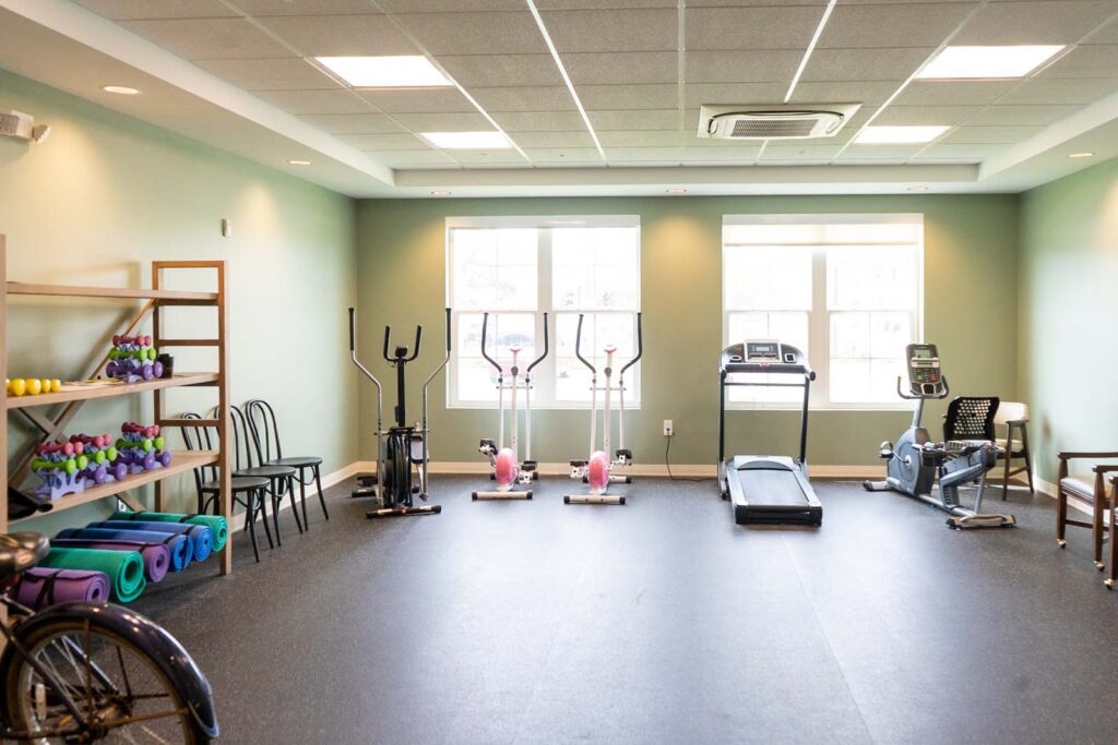 A well-equipped fitness center for residents to stay active at The Arbors at Gulf Breeze, a senior living community.